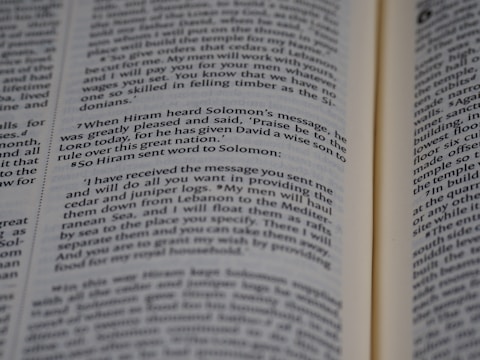 An open book displaying printed text in English. The text appears to be a passage from a religious or historical text, focusing on a conversation between Hiram and Solomon. The book is open to reveal two pages with a paragraph highlighted in some manner.