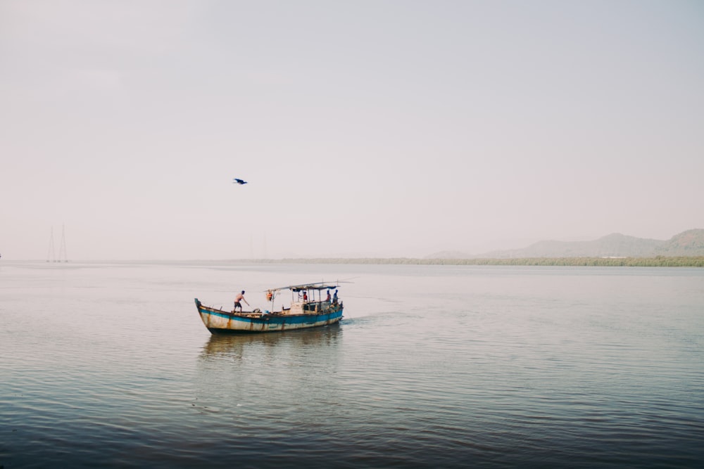 red and white boat on sea during daytime