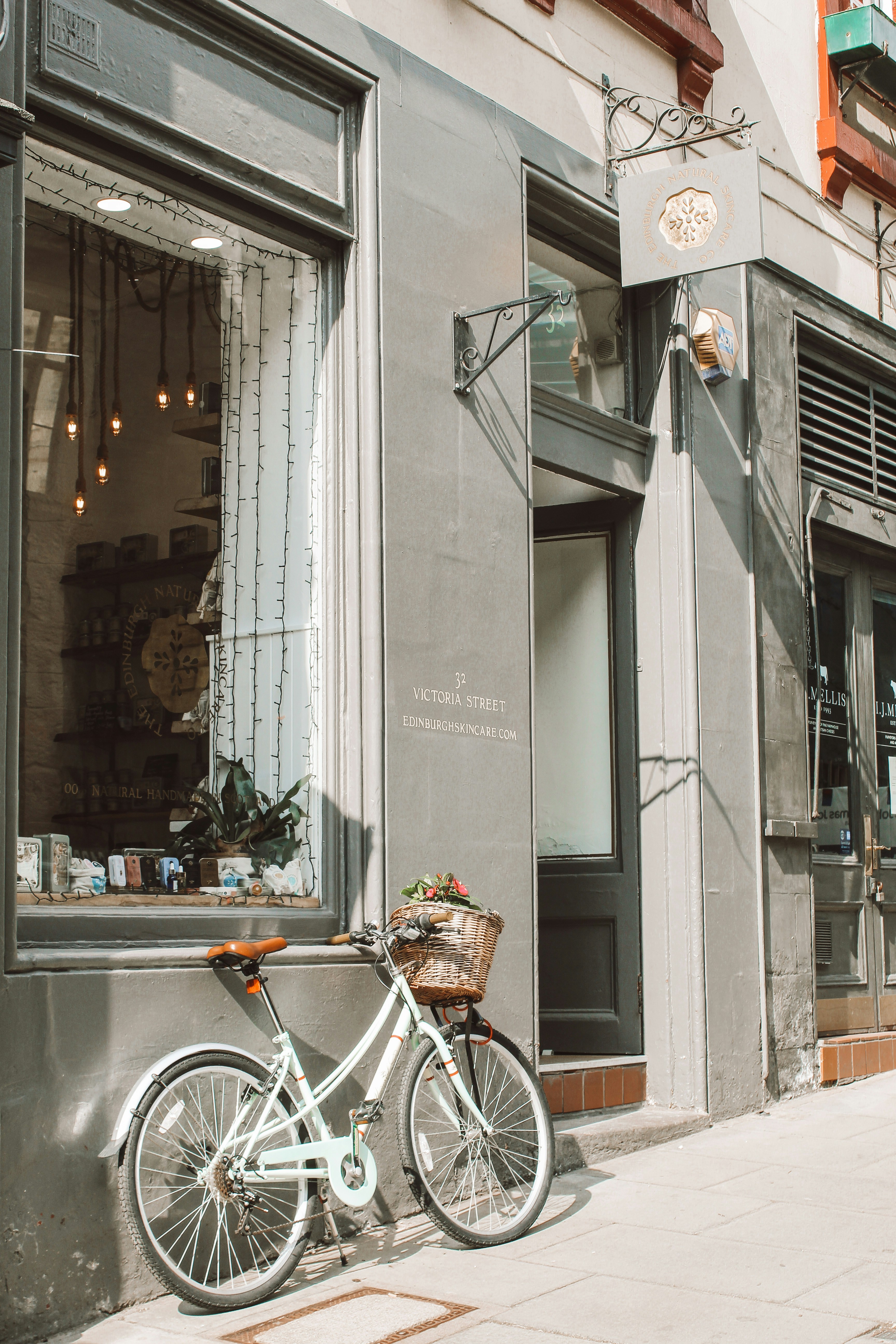 white city bike parked beside store
