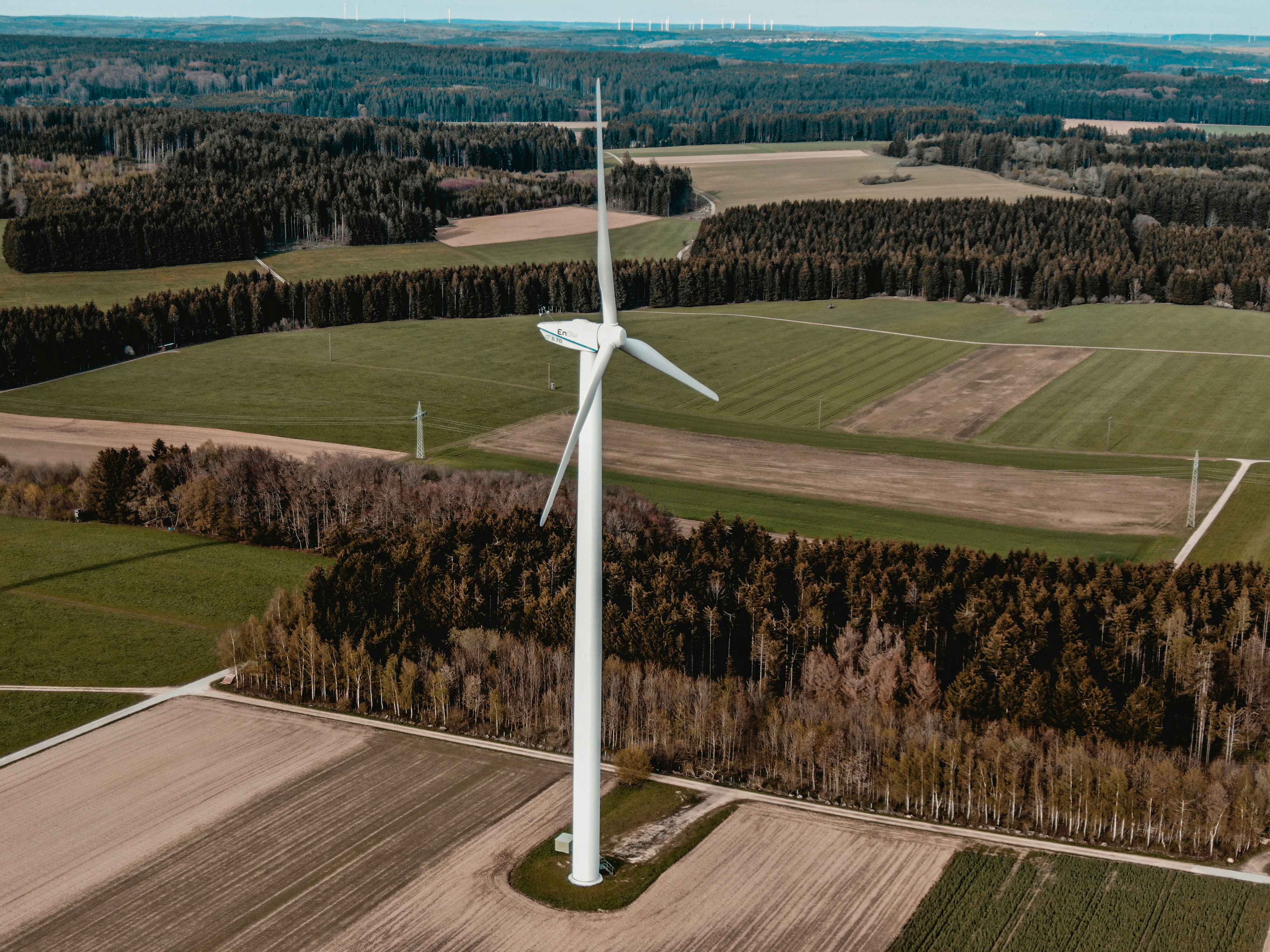 white windmill on green grass field during daytime