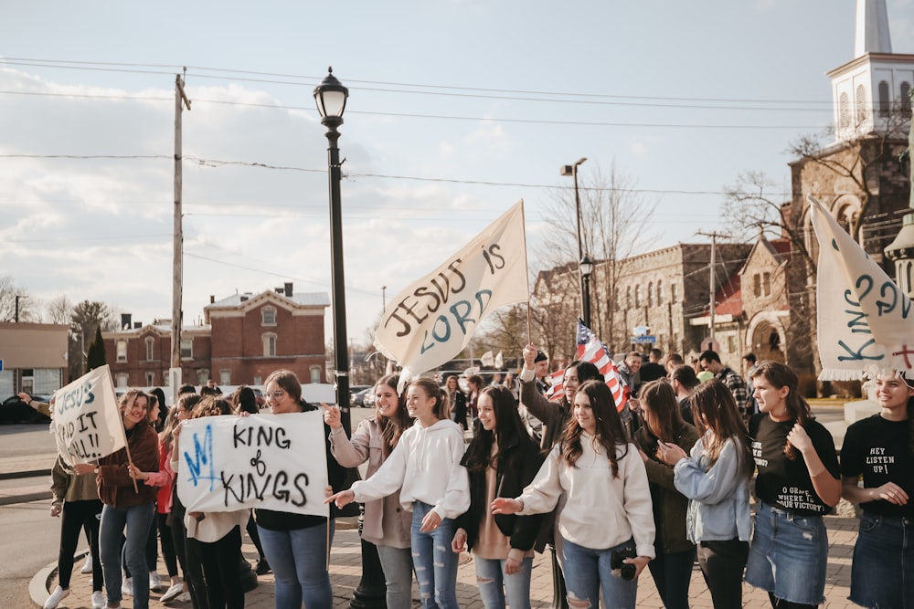 people standing on road during daytime