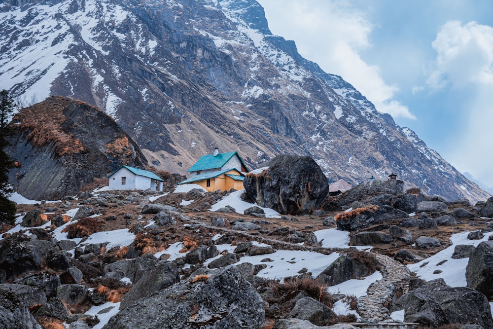 houses on snow covered ground near mountain during daytime