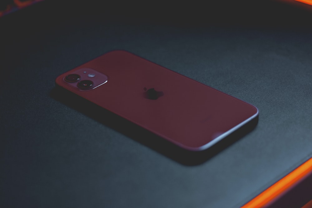 red iphone 7 on black table