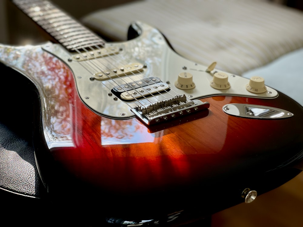 red and white stratocaster electric guitar