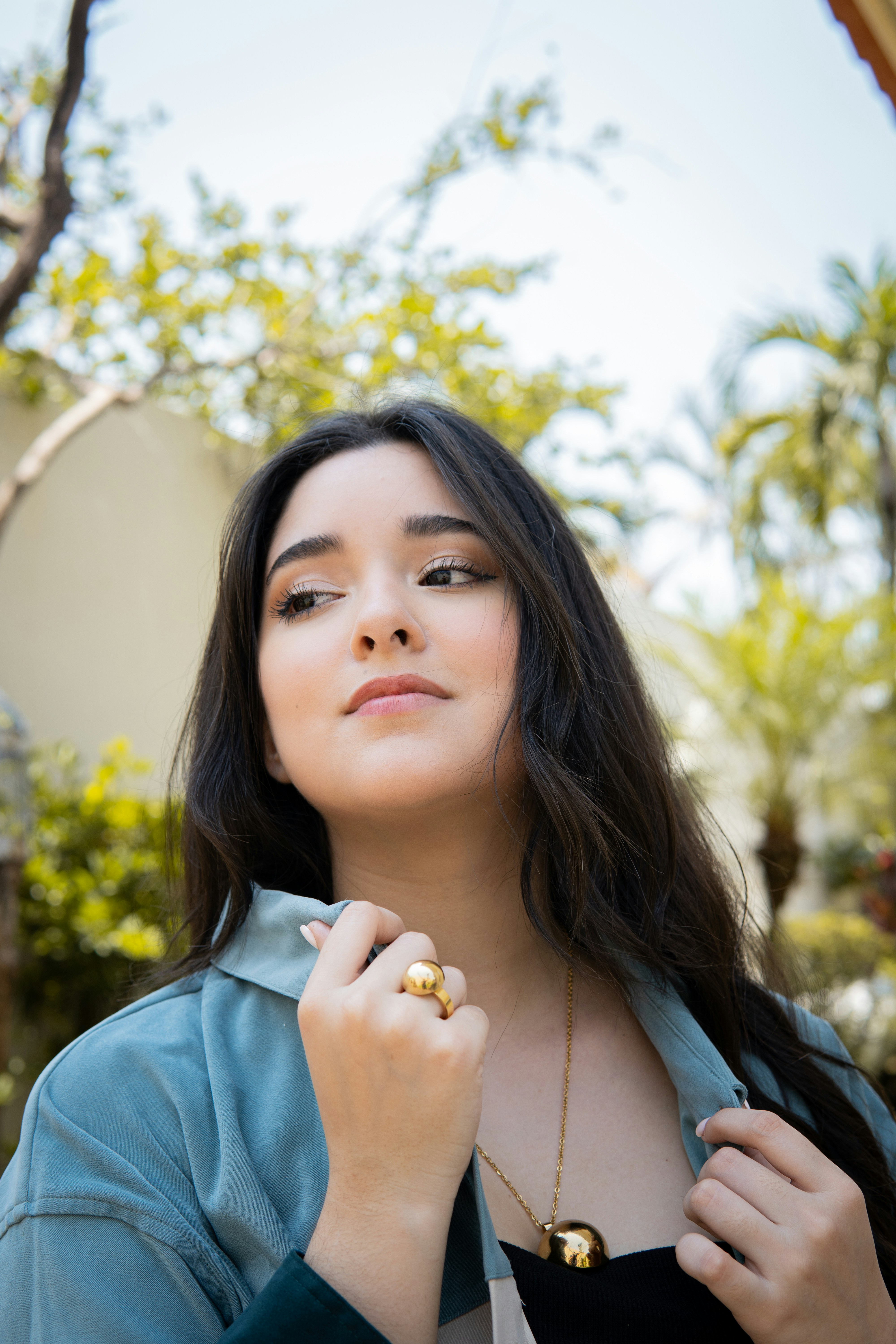 woman in blue collared shirt with silver ring