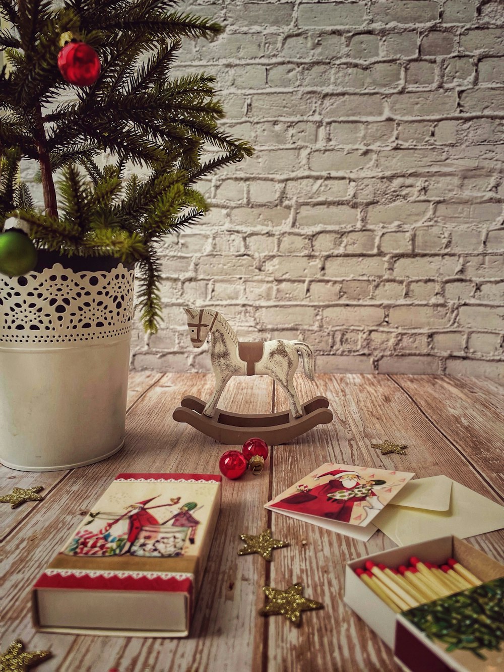 brown wooden rocking horse beside green potted plant