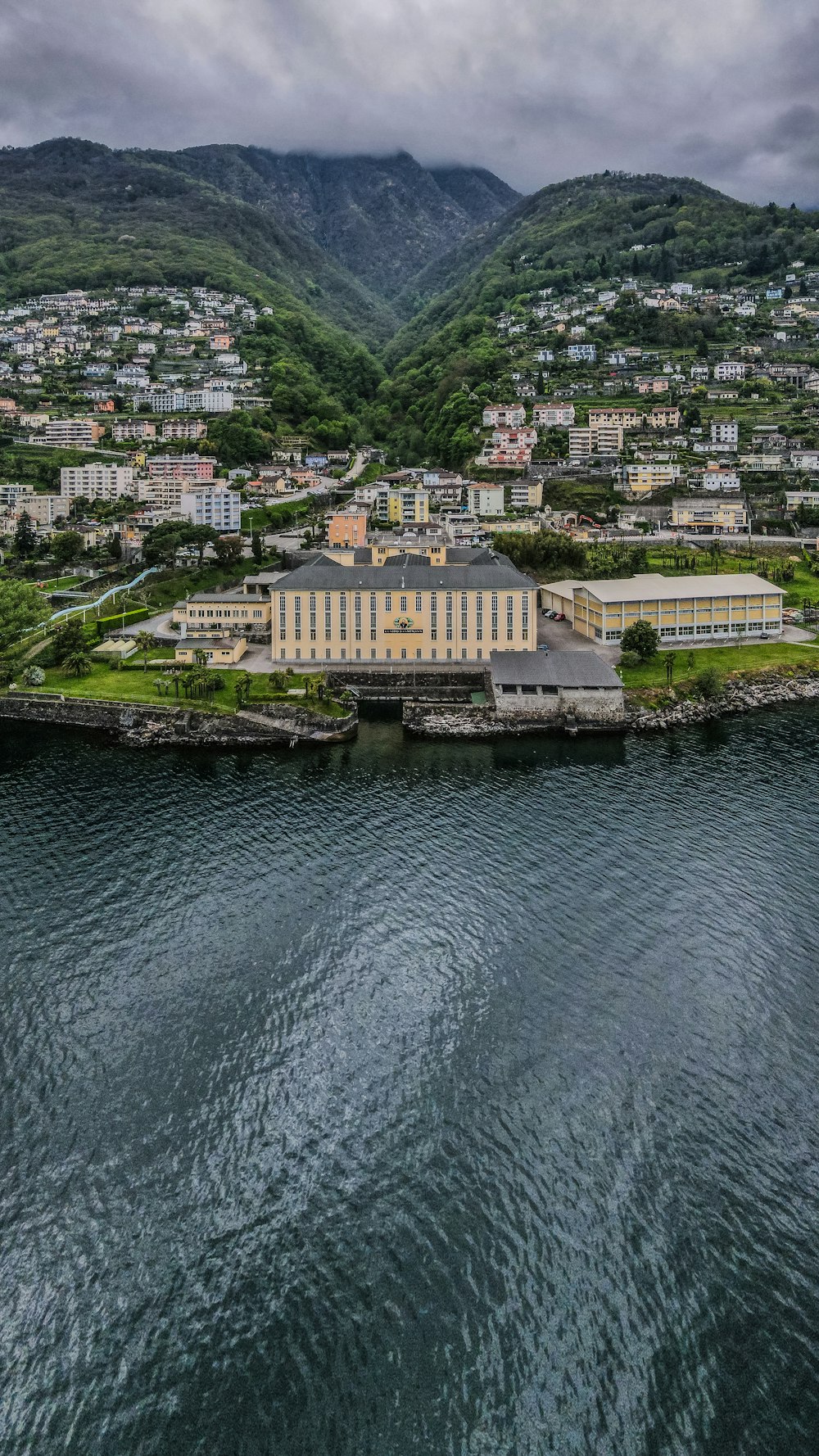 aerial view of city buildings near body of water during daytime