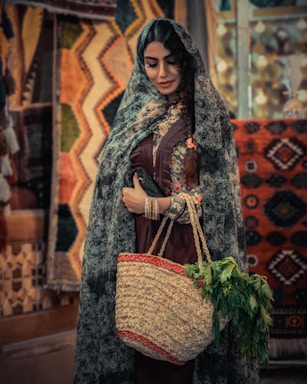 A warm Andean woman smiling while holding a handmade woven basket in the Sacred Valley