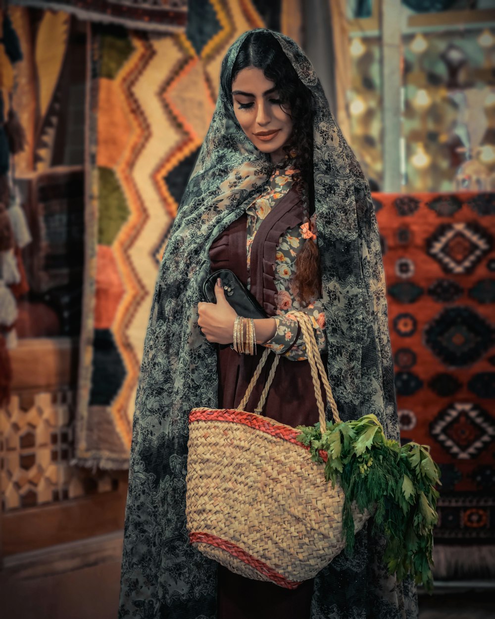 woman in brown and red hijab holding green plant