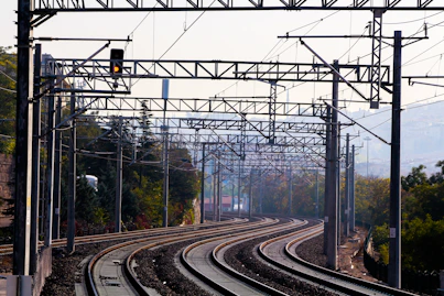 train rail tracks near trees during daytime