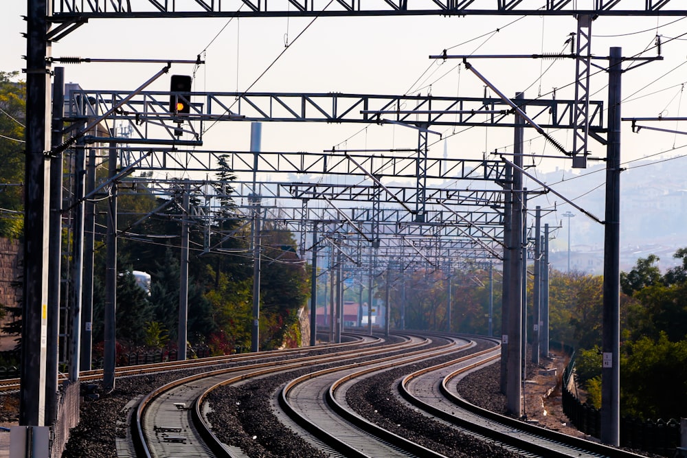 train rail tracks near trees during daytime