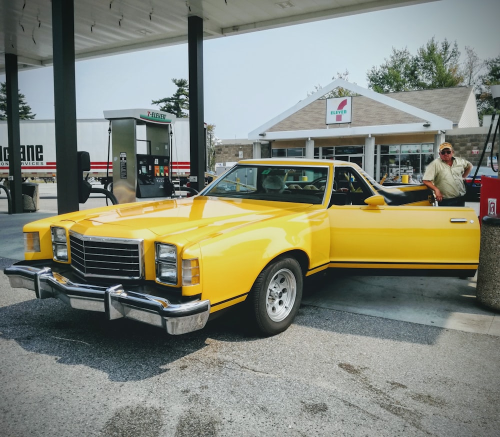 yellow car parked near white building