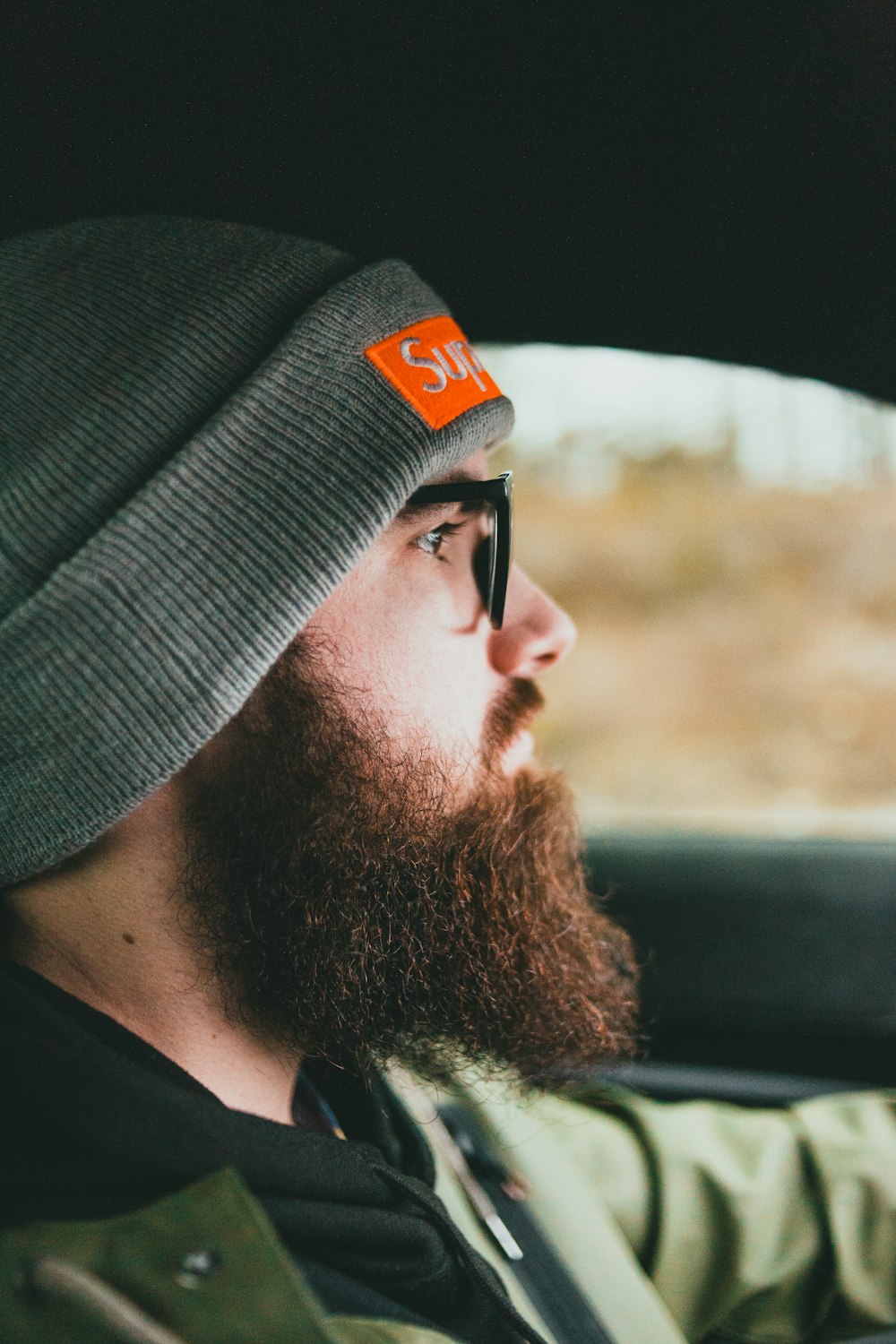 man in black knit cap and black framed eyeglasses