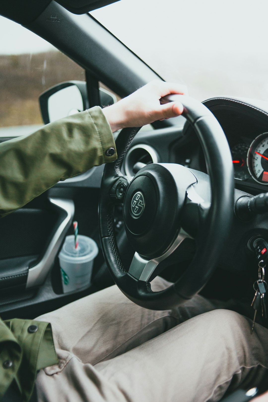 person holding black steering wheel