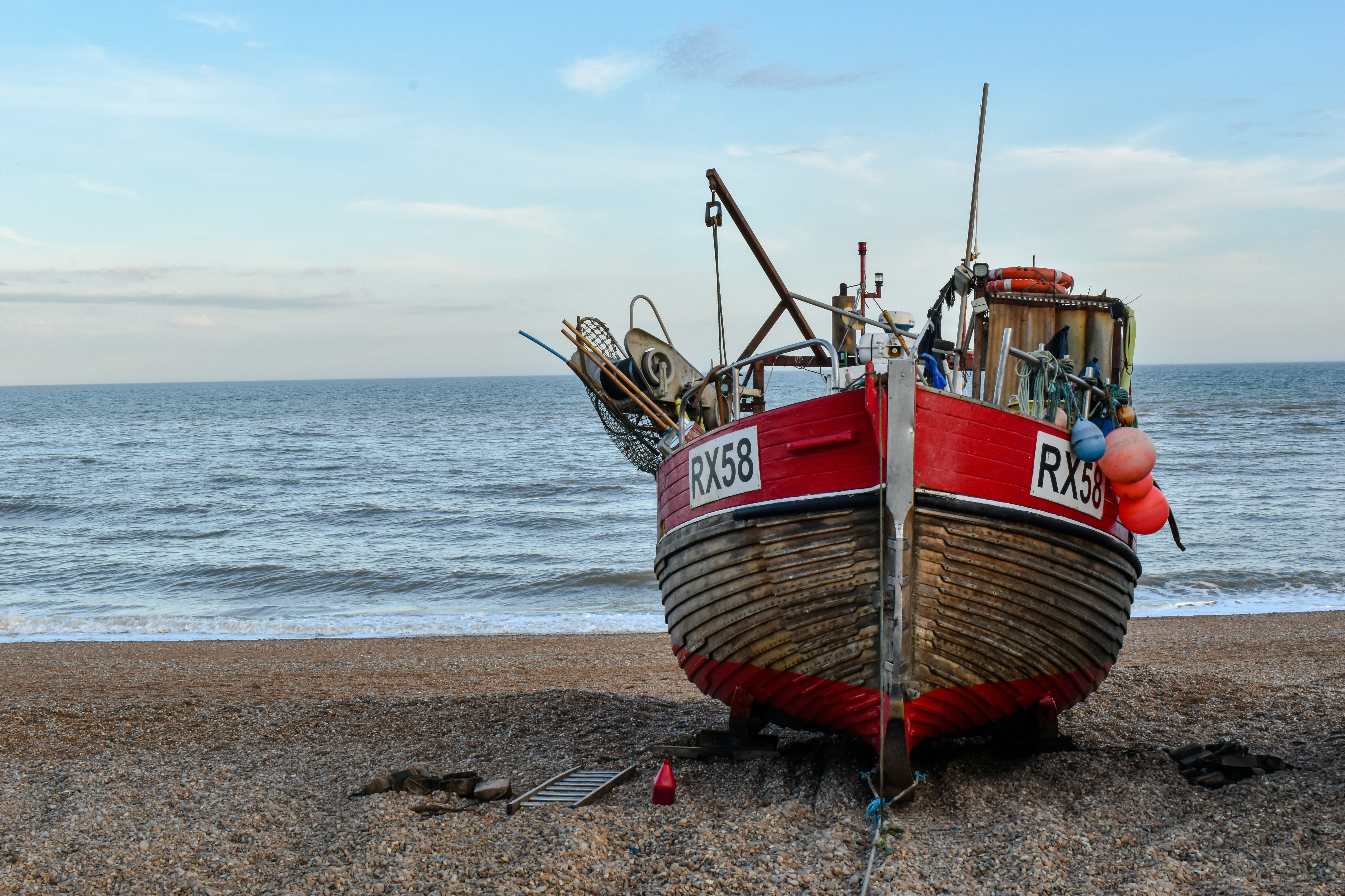 brown and red boat on beach during daytime