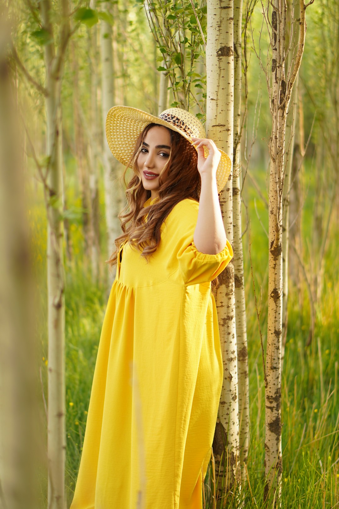 woman in yellow dress wearing brown straw hat