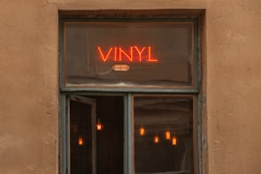 Close-up of a storefront with clean vinyl signage displaying a local business logo