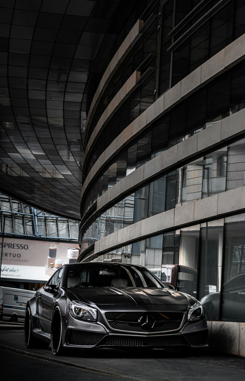 cars parked in front of brown building