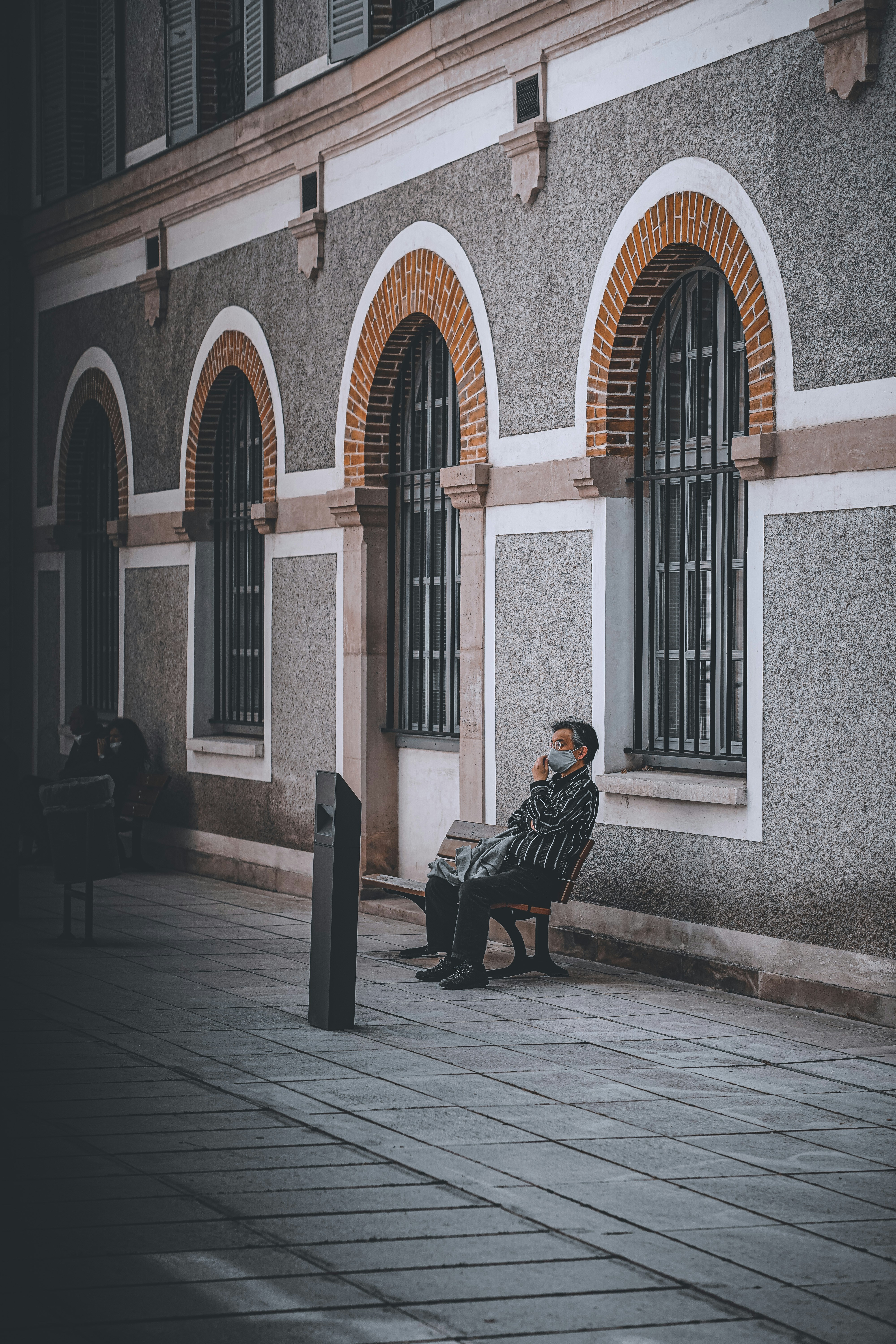 A person sitting alone, looking distressed