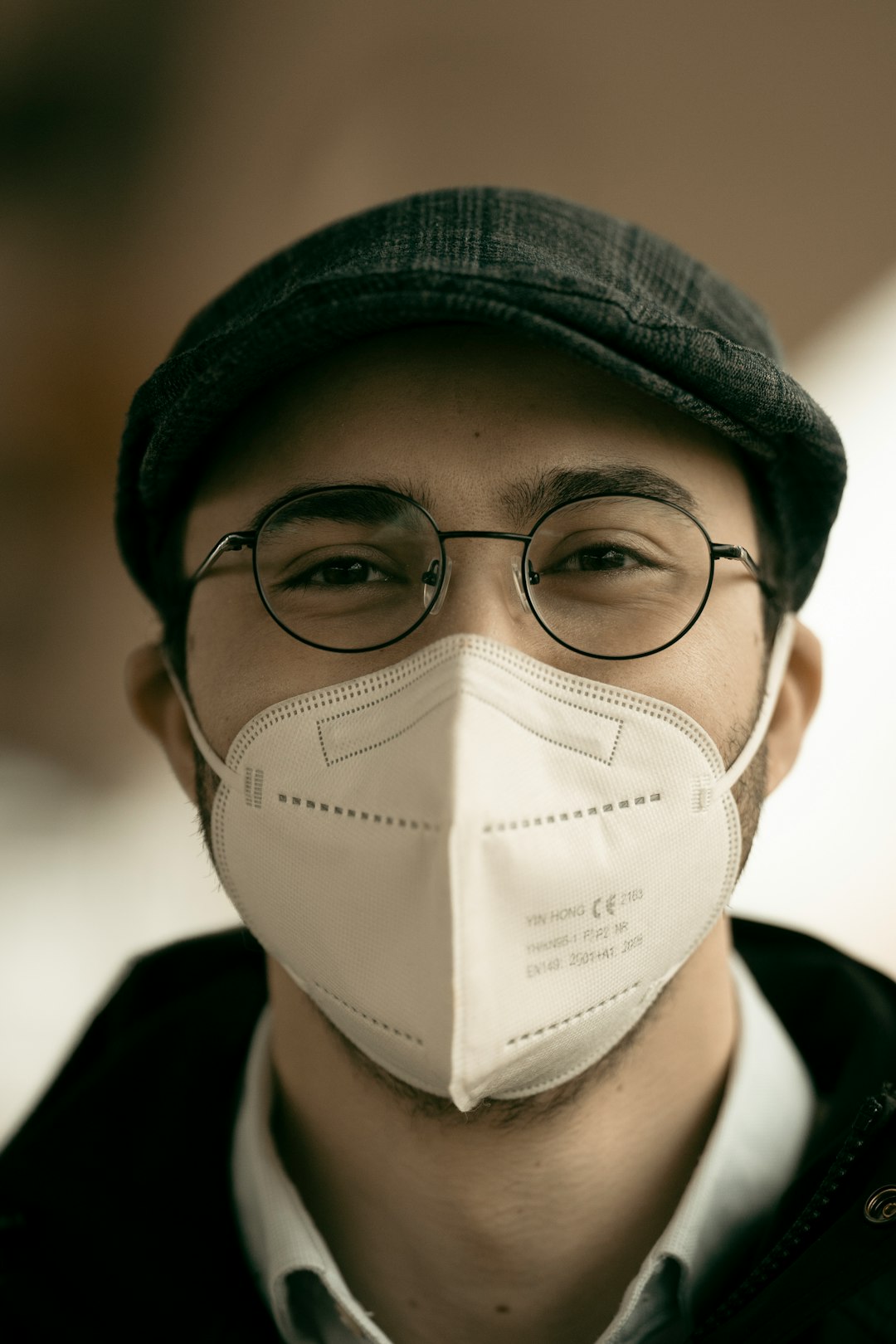 man in black knit cap and black framed eyeglasses