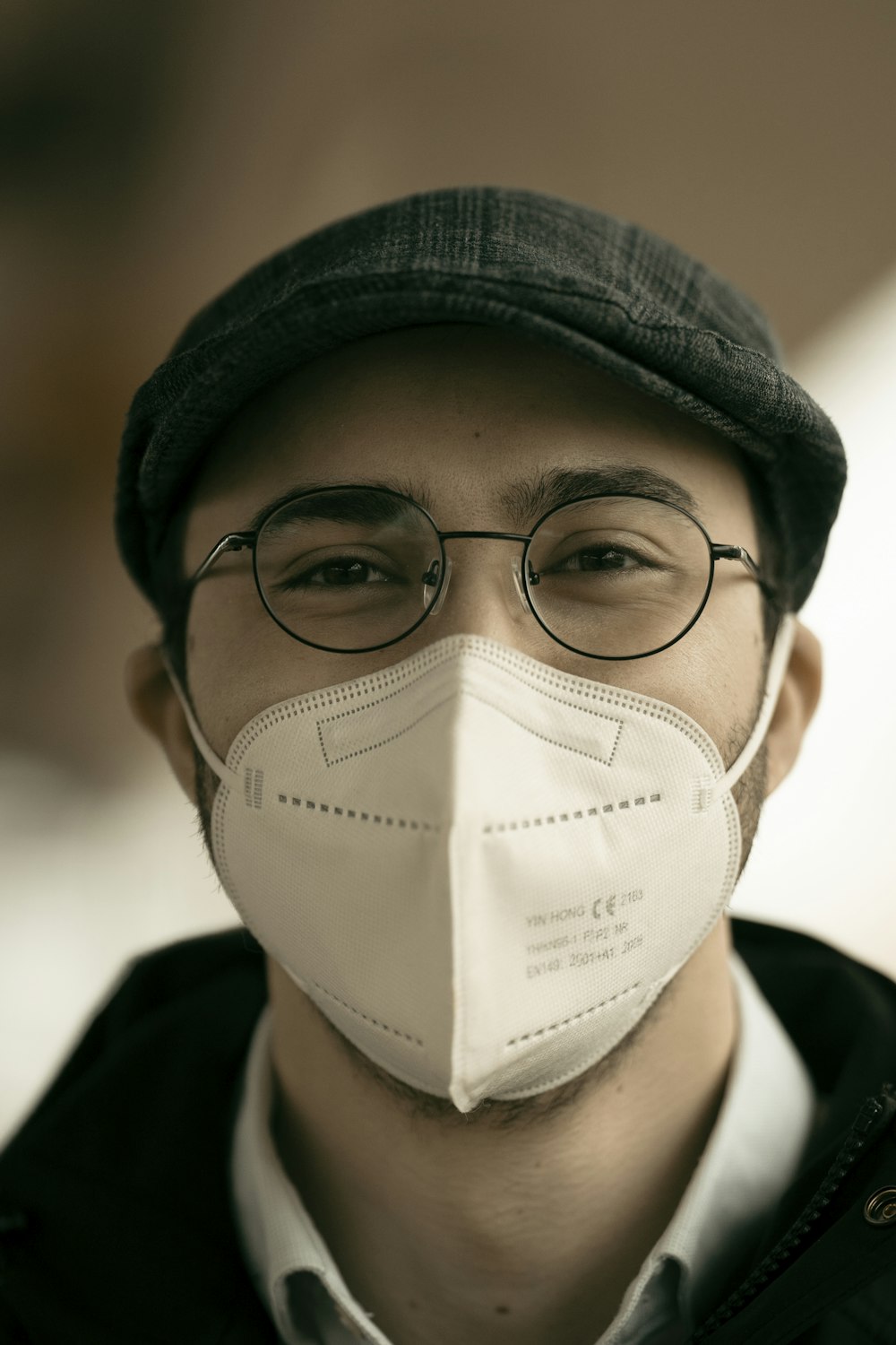 man in black knit cap and black framed eyeglasses