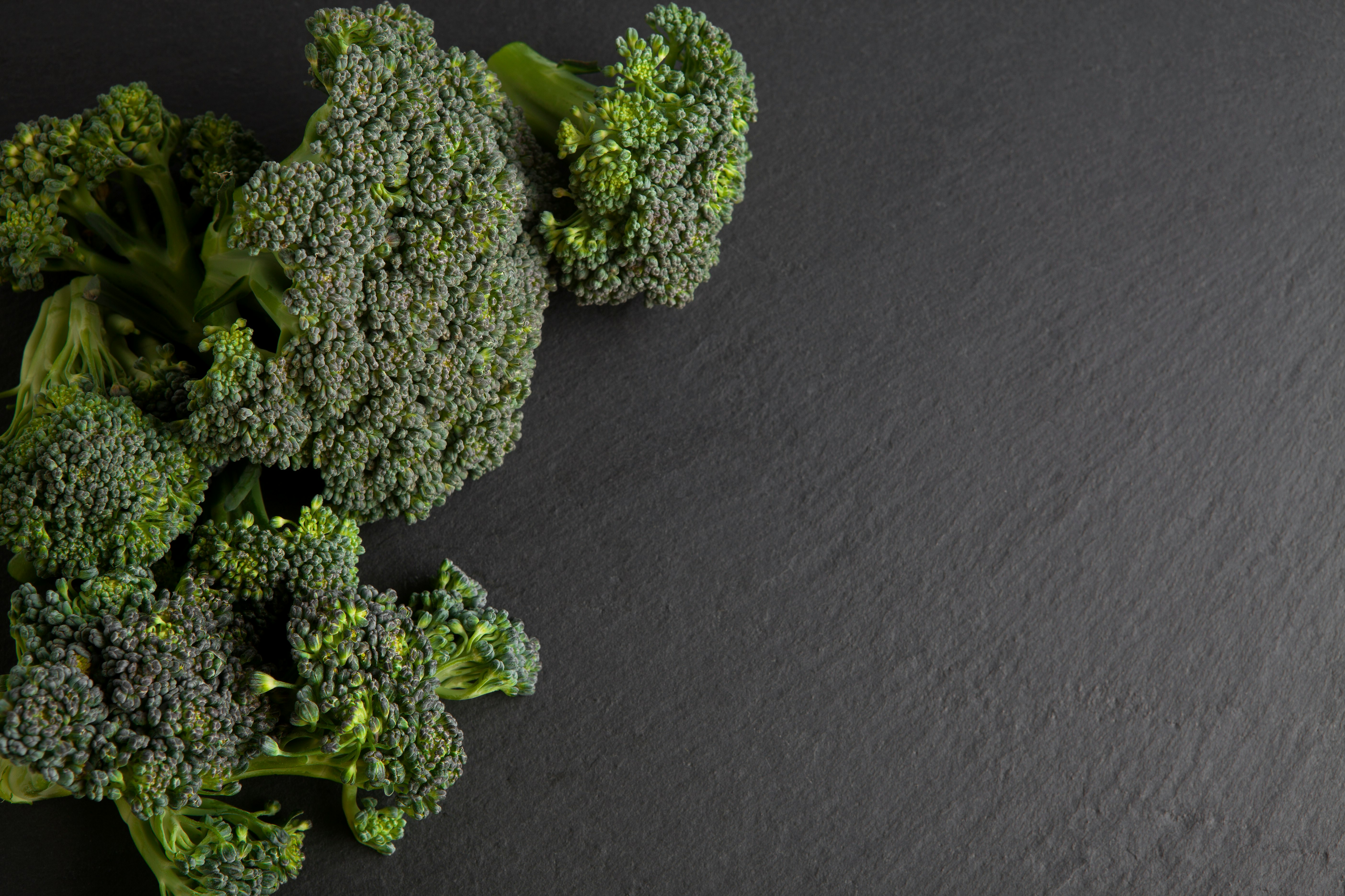 green broccoli on black textile