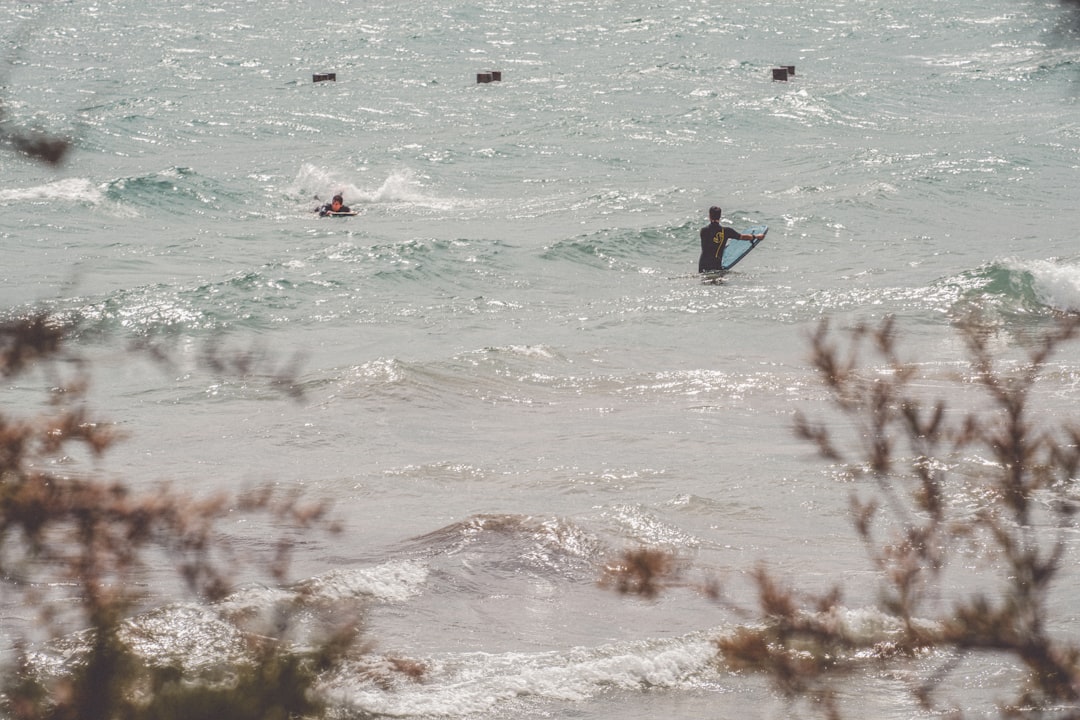 person surfing on sea waves during daytime