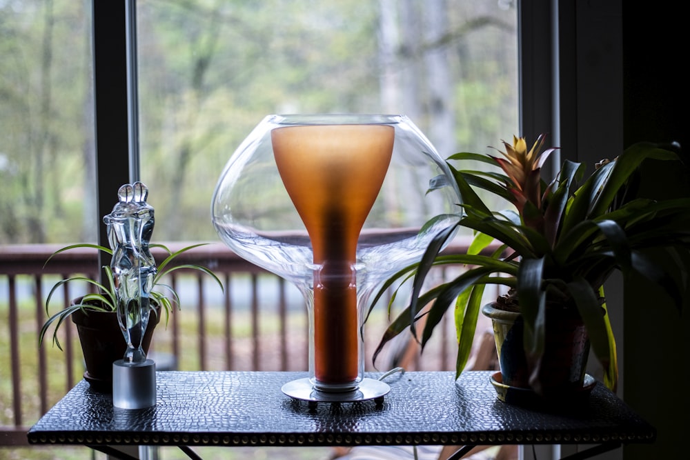 clear wine glass with brown liquid inside