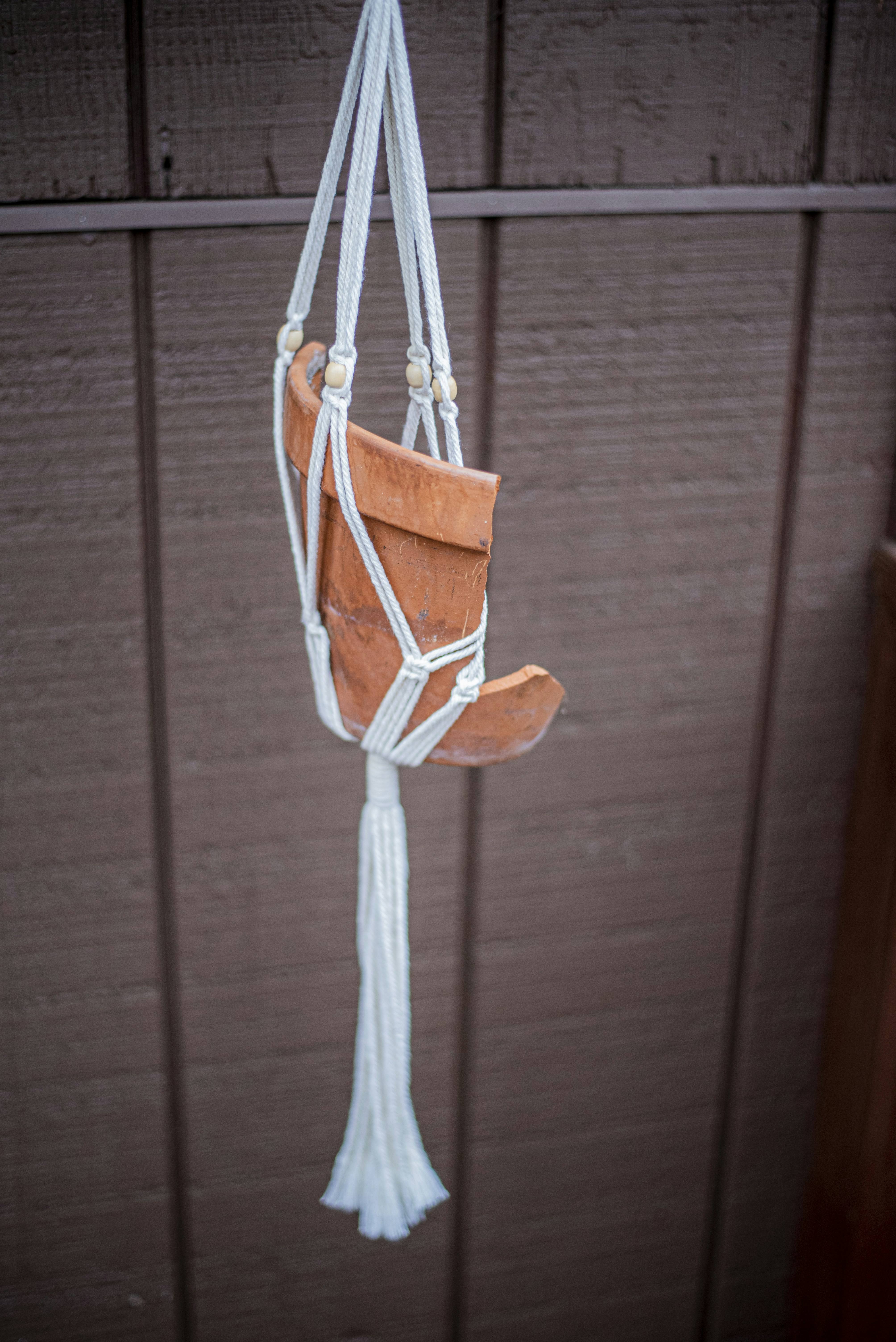 brown and white rope hanged on brown wooden wall