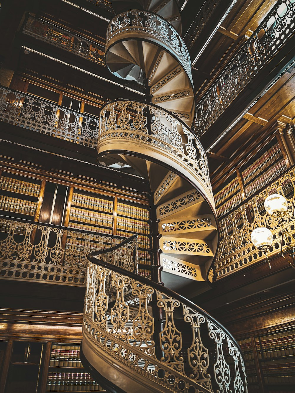 brown wooden spiral staircase with black metal railings