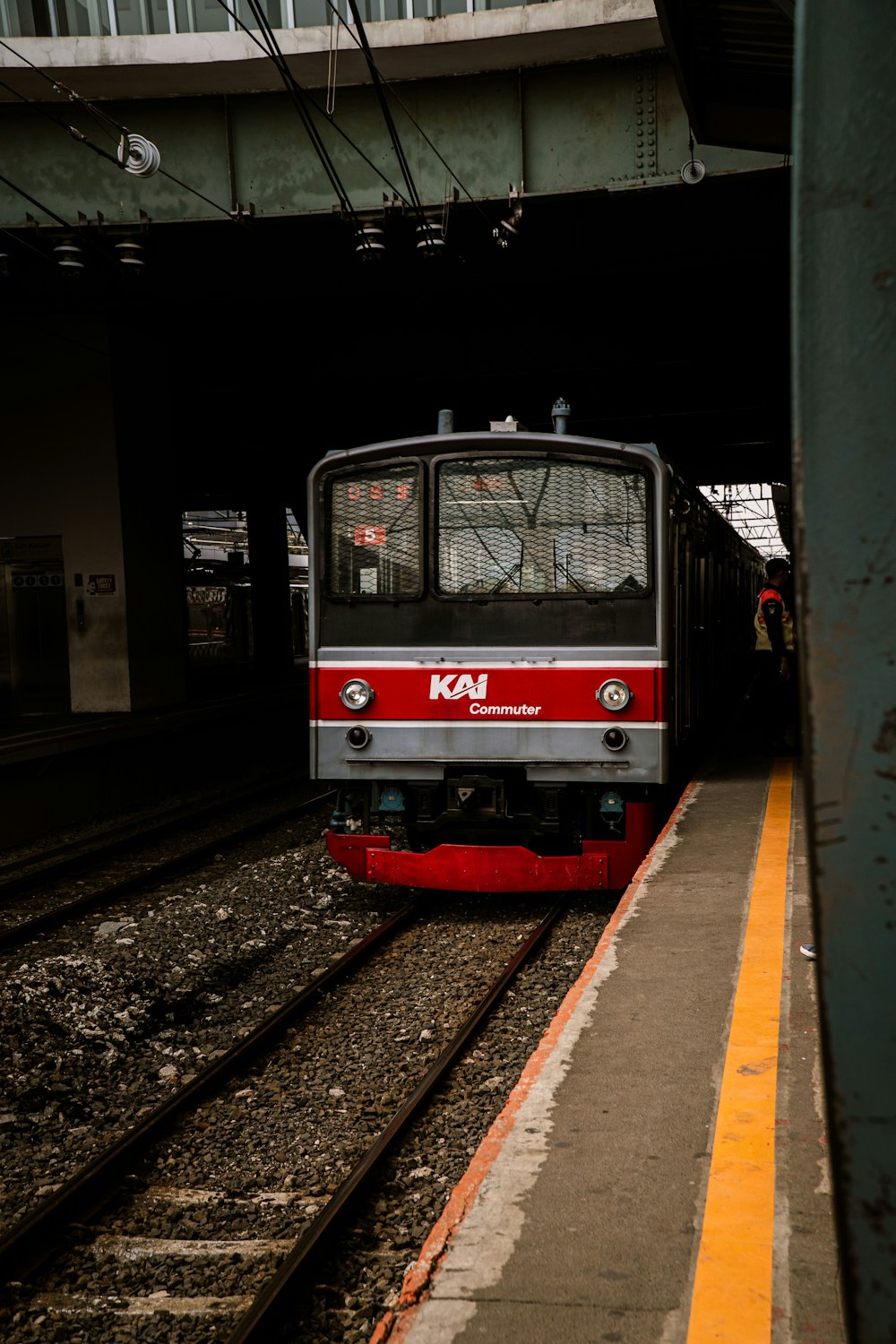 red and white train on rail tracks