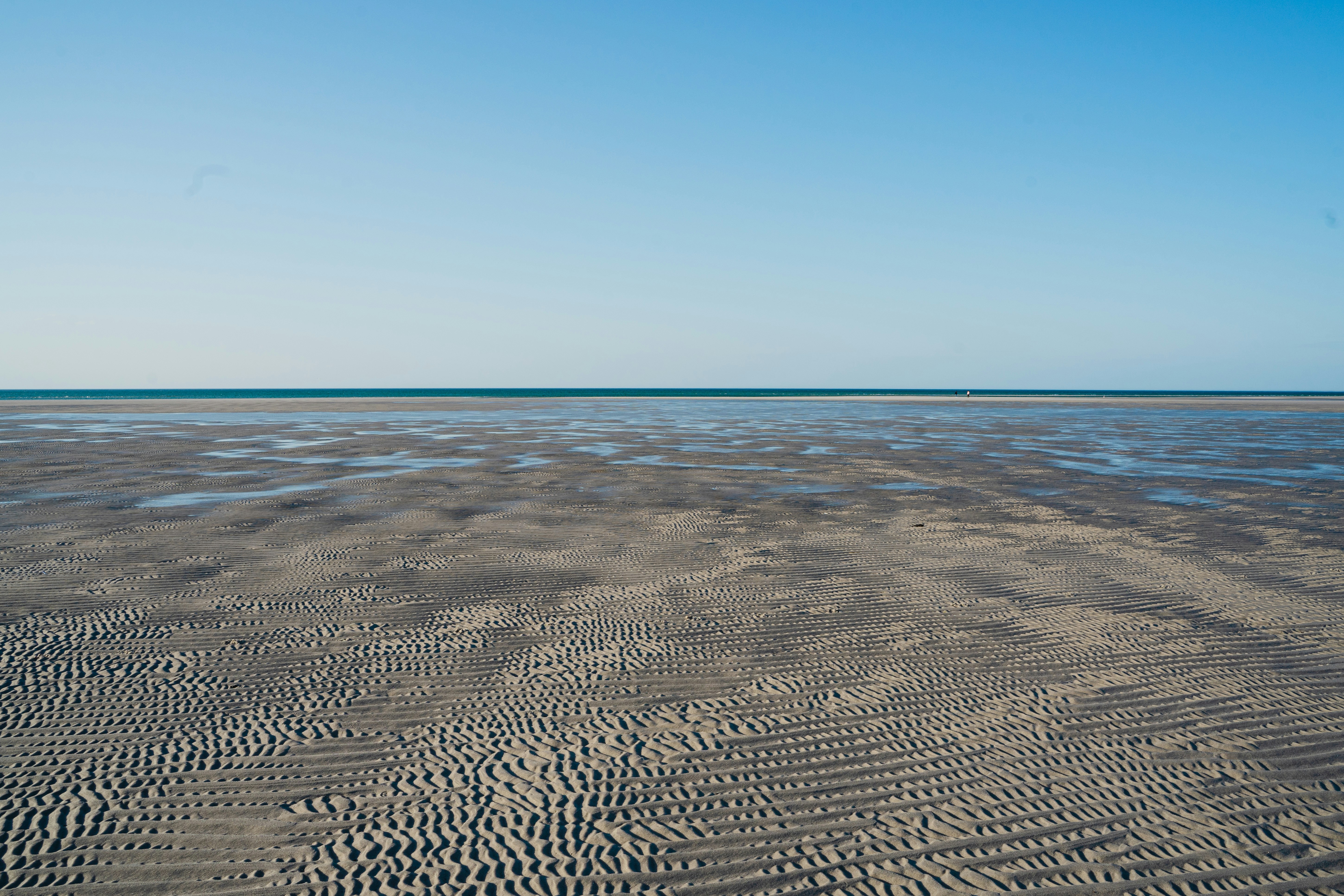 blue sea under blue sky during daytime, Low tide flats on Cape Cod.