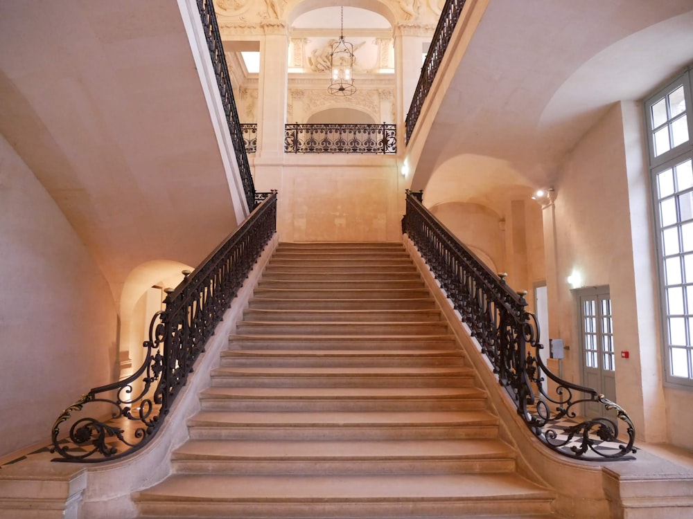 brown wooden staircase with black metal railings