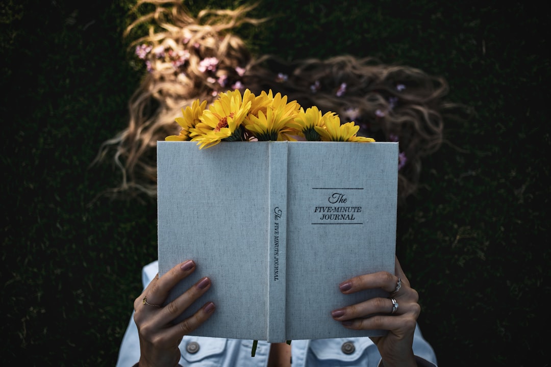 person holding white book page