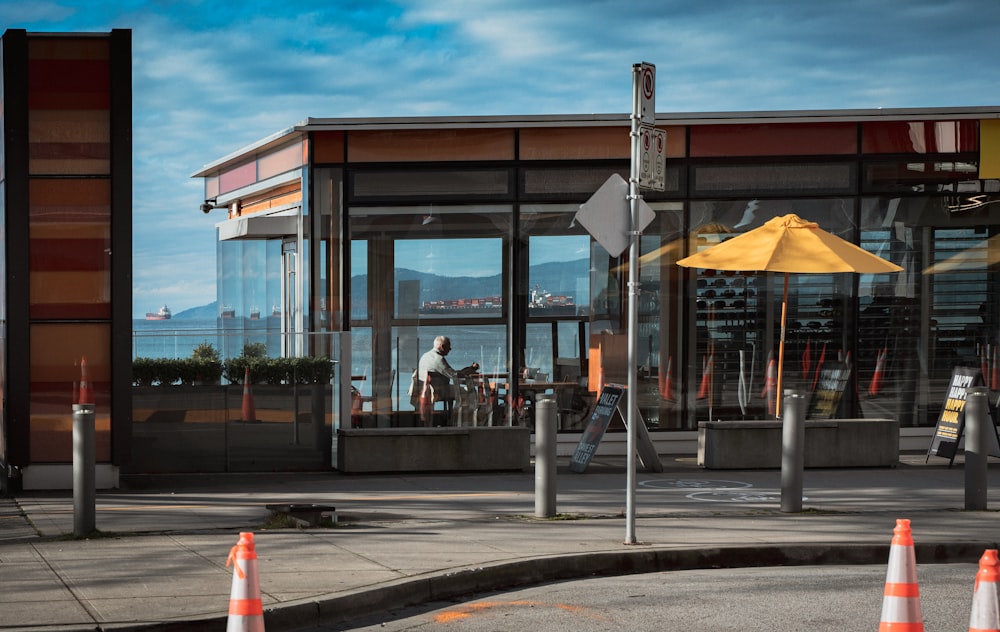 white and orange traffic cone on sidewalk during daytime