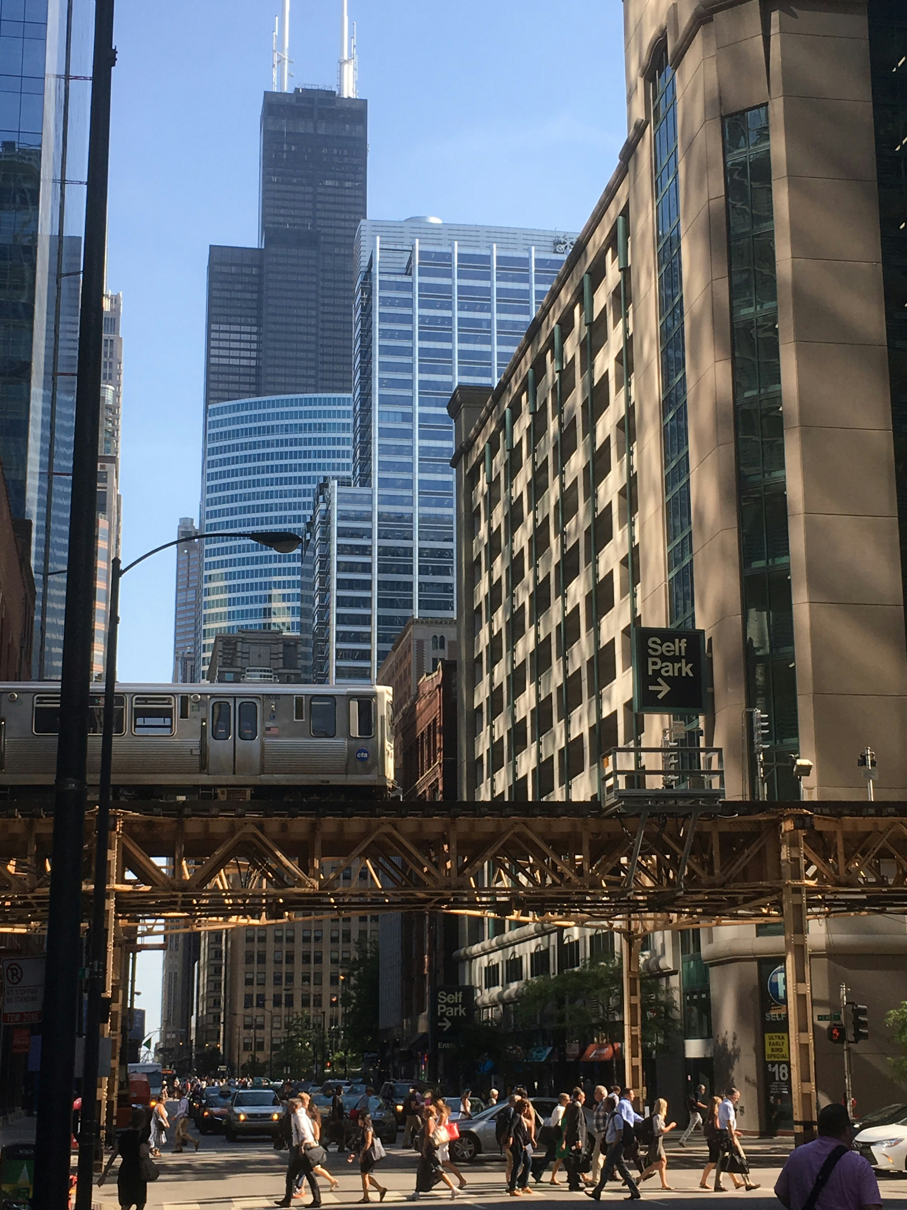 Chicago, IL Loop streetscape with L Train during busy rush hour. Willis Tower, Parking Garage, 