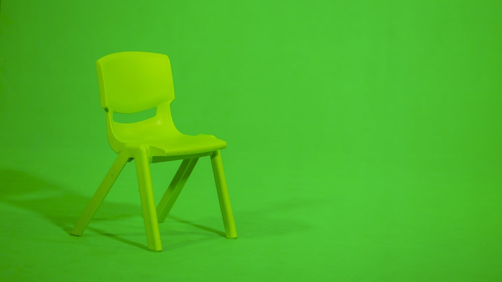 green plastic chair on green floor