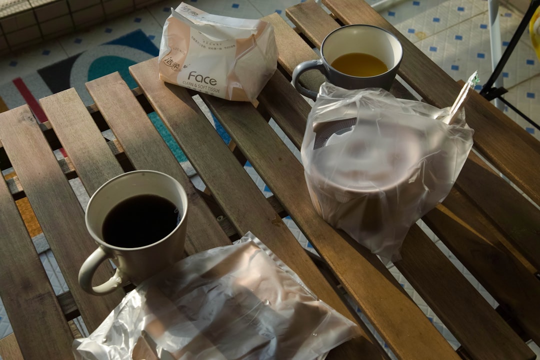white ceramic mug on brown wooden table