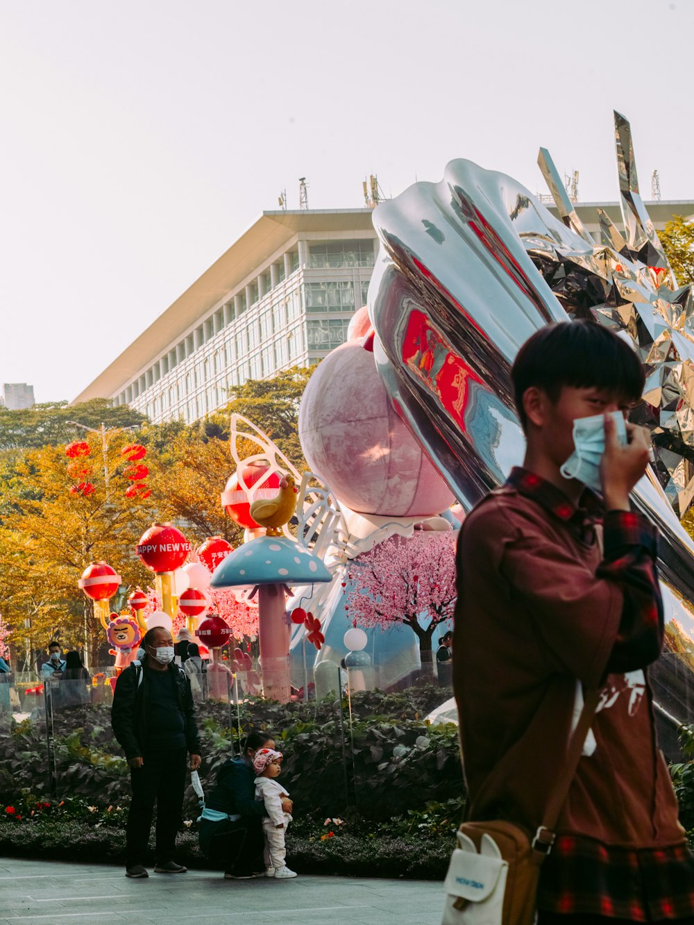 man in black jacket standing near red and white balloons during daytime