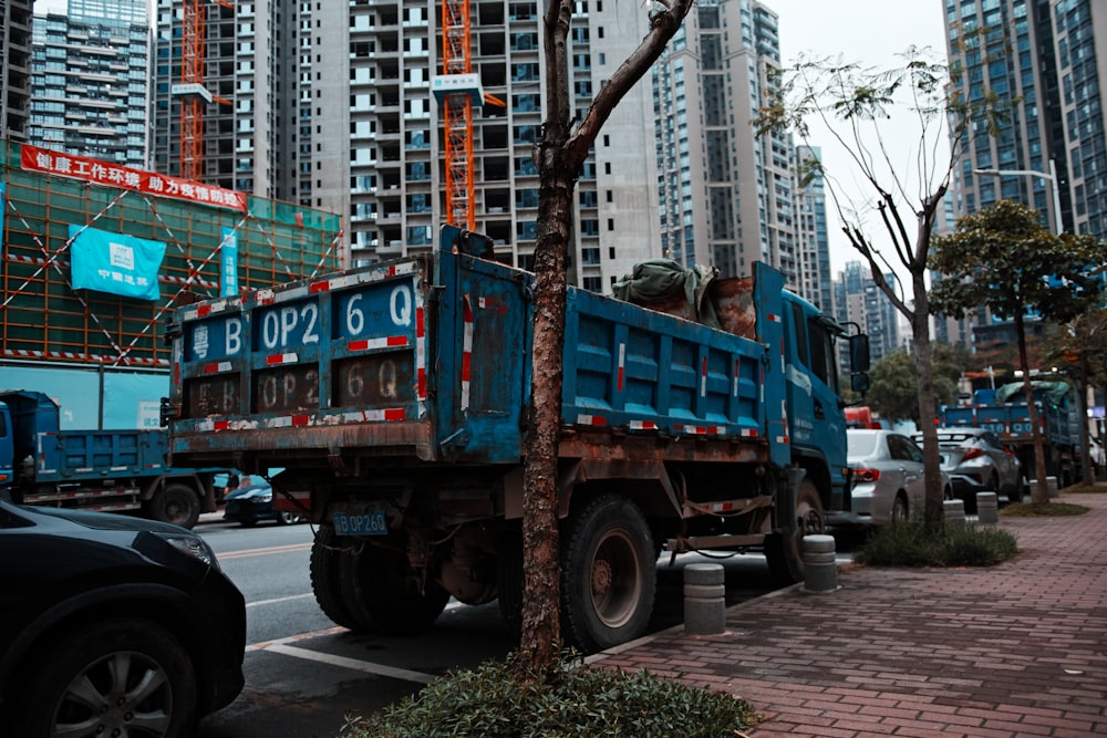 blue truck on road during daytime