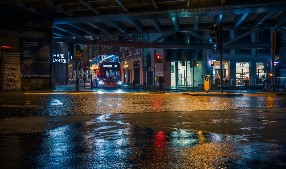 red bus on road during night time