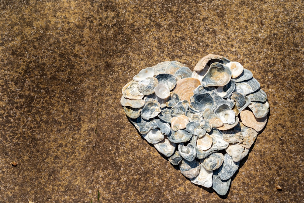 silver heart shaped ornament on brown textile