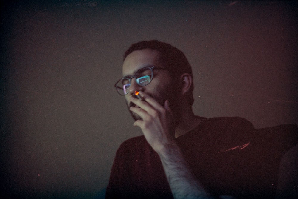 man in red long sleeve shirt wearing eyeglasses