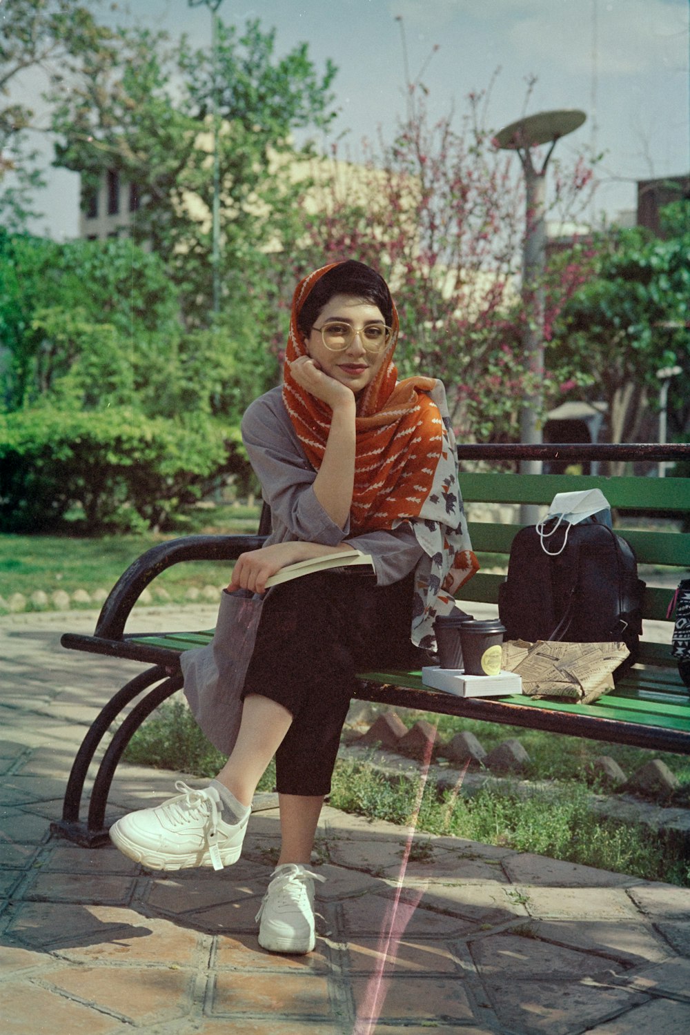 woman in brown long sleeve shirt sitting on black metal bench