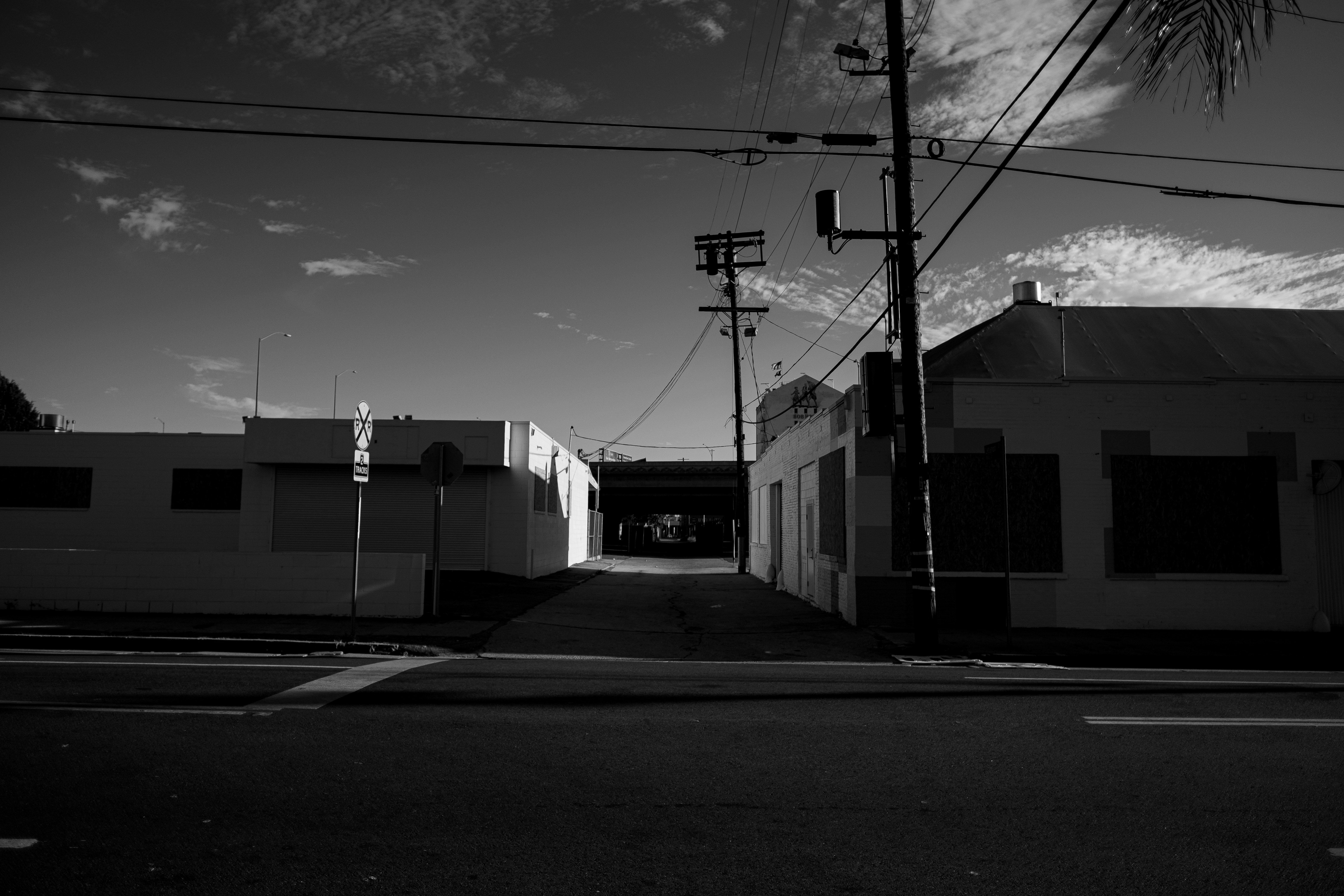 grayscale photo of a street with light posts