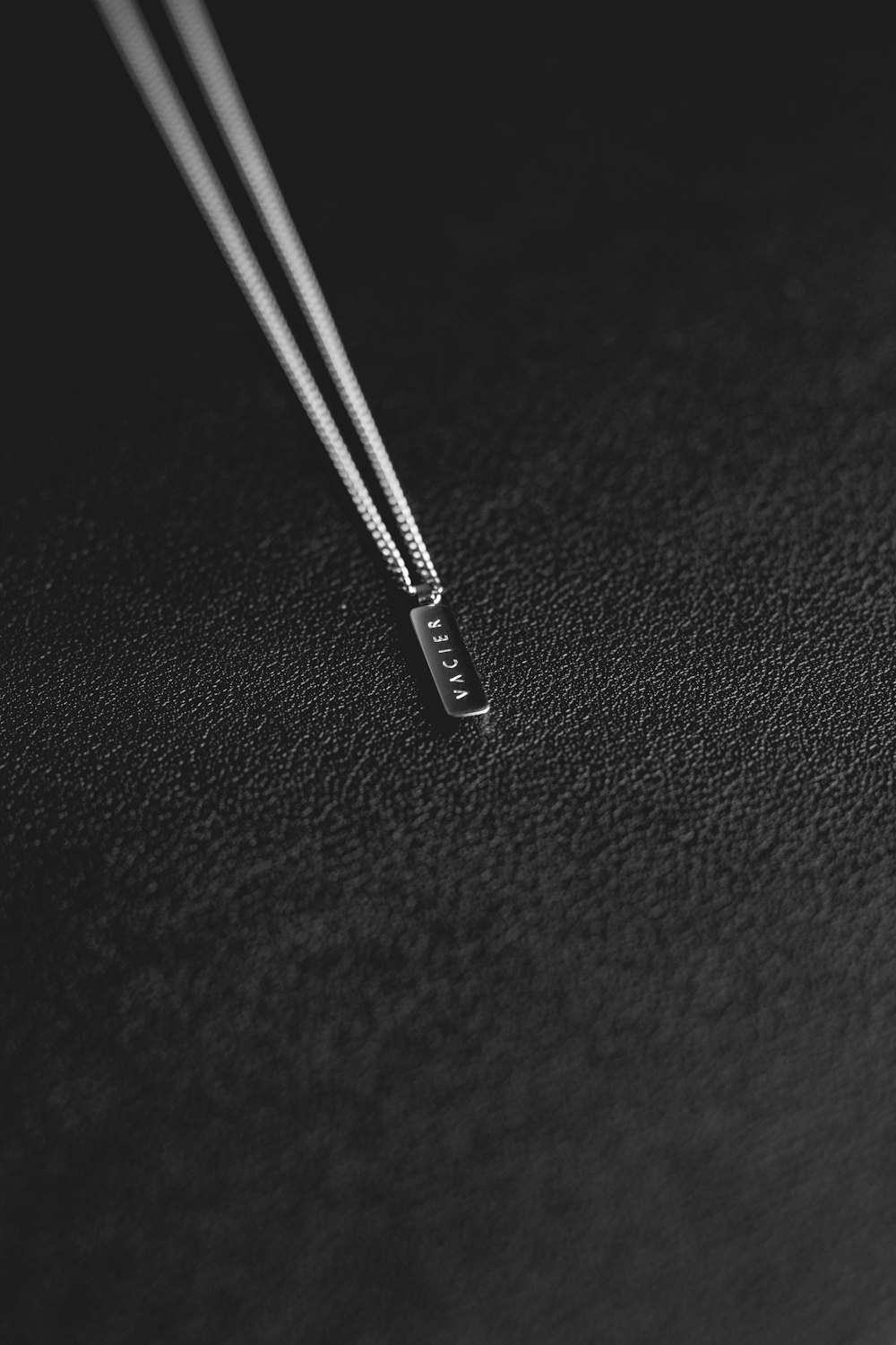 silver pin on black textile