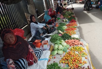 A group of women vendors selling fresh produce at a bustling market in Haiti.