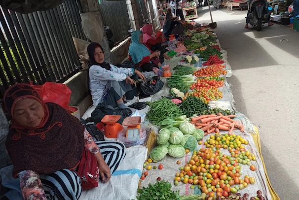 A group of women farmers proudly displaying their organic produce at a local market.