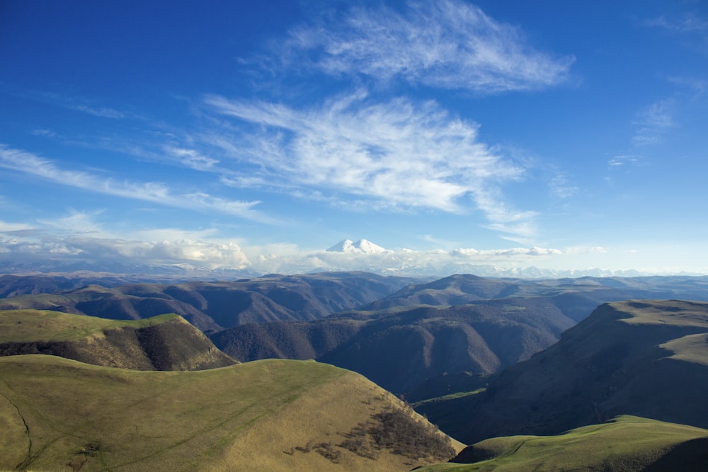 brown and green mountains under blue sky during daytime