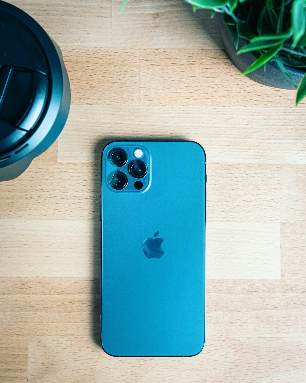 blue iphone 5 c on brown wooden table